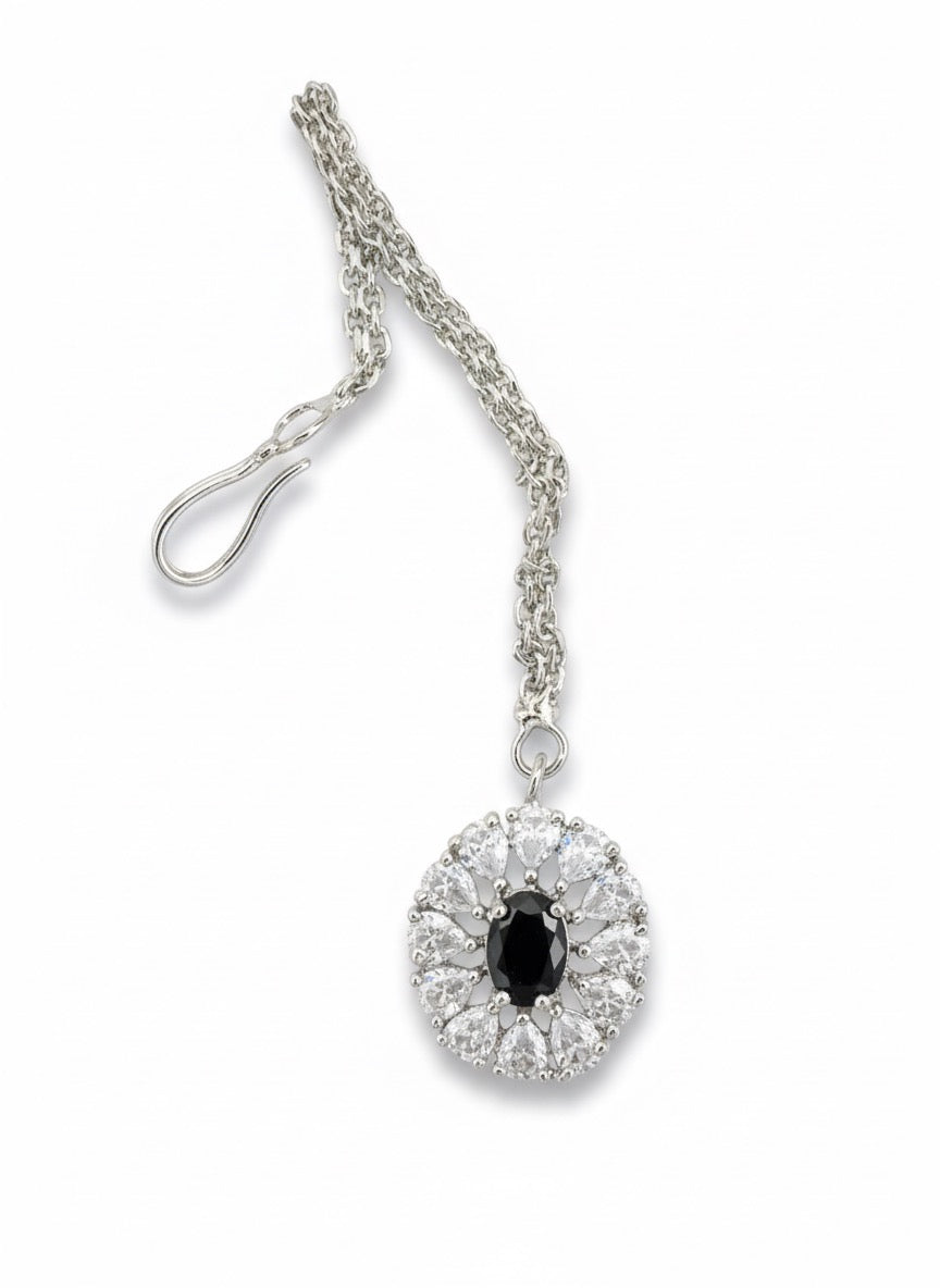silver chain necklace with oval black gemstone pendant surrounded by clear crystals